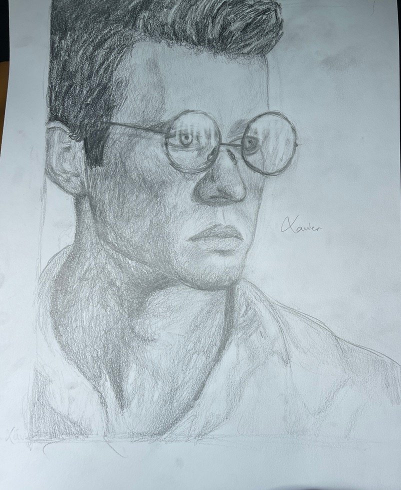 Xavier’s signed pencil portrait of a person wearing round glasses