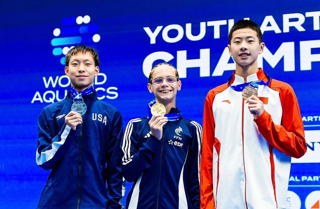 Xavier in his USA jacket holding his World Youth silver medal